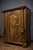 A richly carved, solid wood display cabinet dating from the 17th century. the front is adorned with a central molded and...