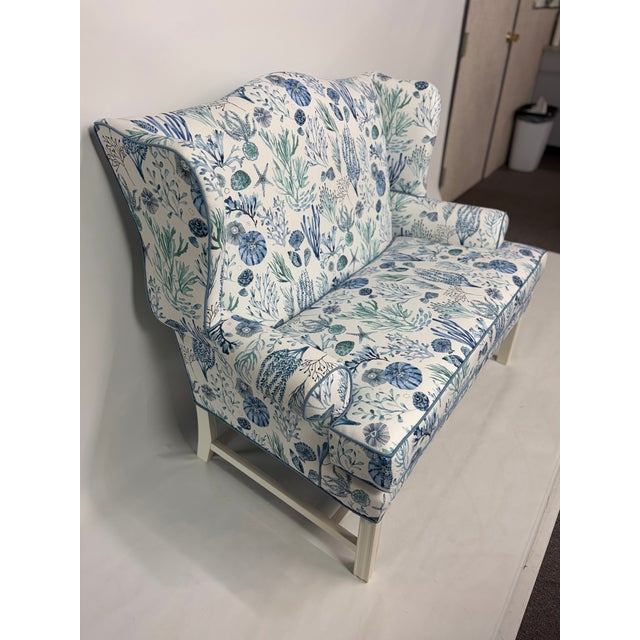 This beautifully upholstered loveseat features a serene coastal motif with coral, shells, and sea life in soft shades of...