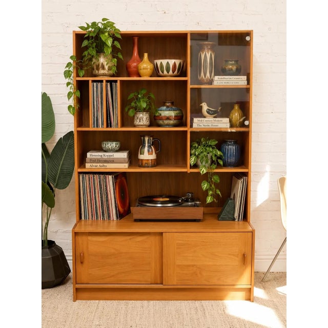A substantial Danish modern multimedia shelf crafted in warm teak with an architectural arrangement of open storage...