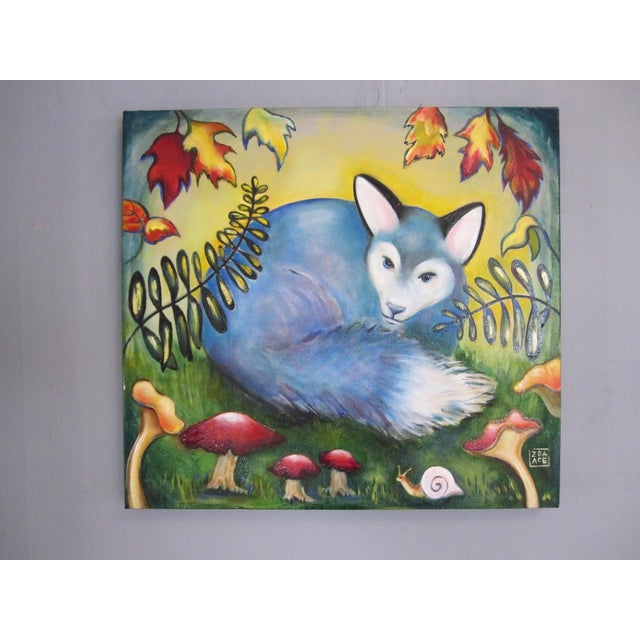 This oil on canvas painting features a serene blue fox nestled among vibrant foliage and whimsical mushrooms, creating a...