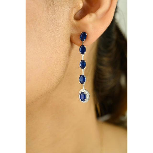 Sleek and sophisticated, these white gold drop earrings are a true celebration of timeless elegance. Featuring 6.32 carats...