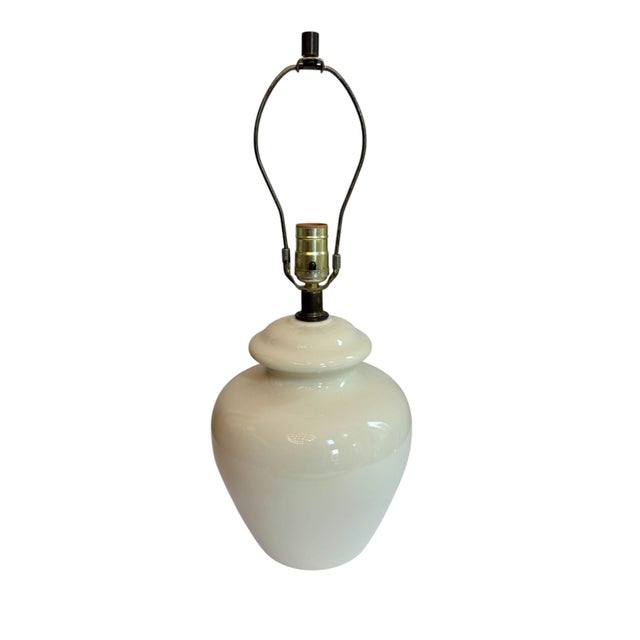 Wescal Cream Urn Lamp This cream colored lamp is shaped like an urn with a lid. It is a solid color with brass toned...