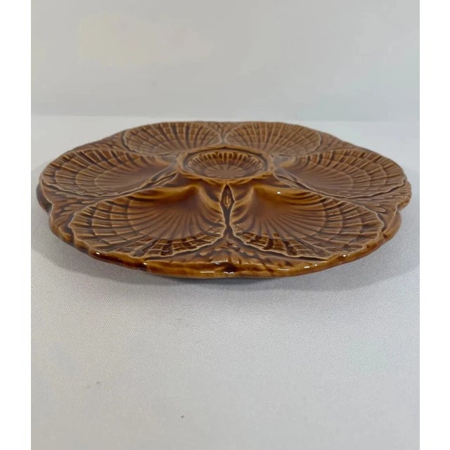 Exquisite antique oyster plate by the renowned French faience manufacturer Sarreguemines, beautifully crafted in richly...