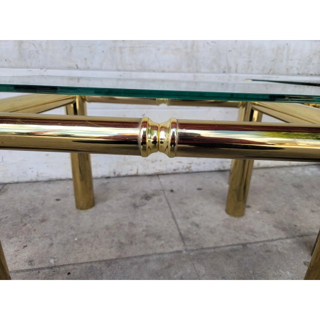 Vintage set of two Mastercraft style brass and glass side tables. Glass inset top. Minor damaged. Glass dimension: 22" ×...