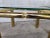 Vintage set of two Mastercraft style brass and glass side tables. Glass inset top. Minor damaged. Glass dimension: 22" ×...