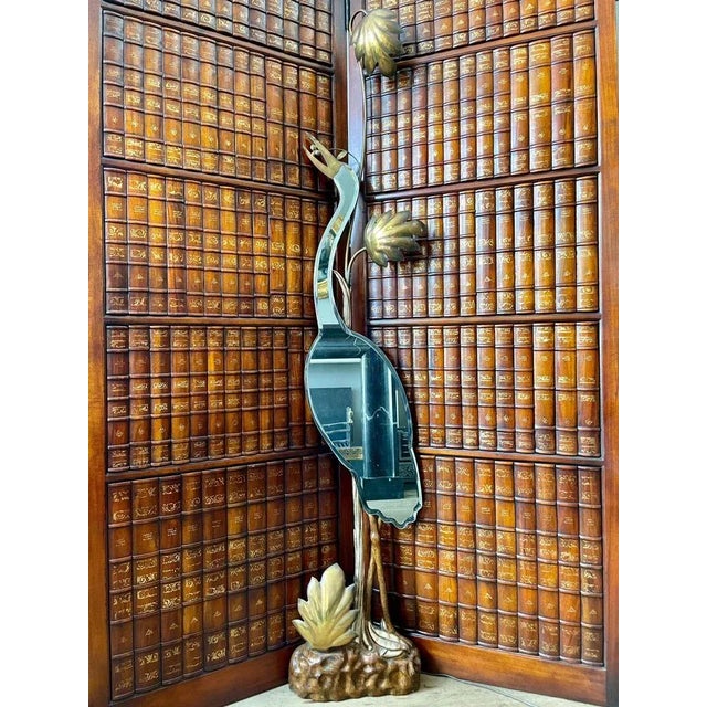 An extraordinary wall mounted floor lamp in the form of a Heron in brass, gilt wood and mirror. The gilt base and foliage...