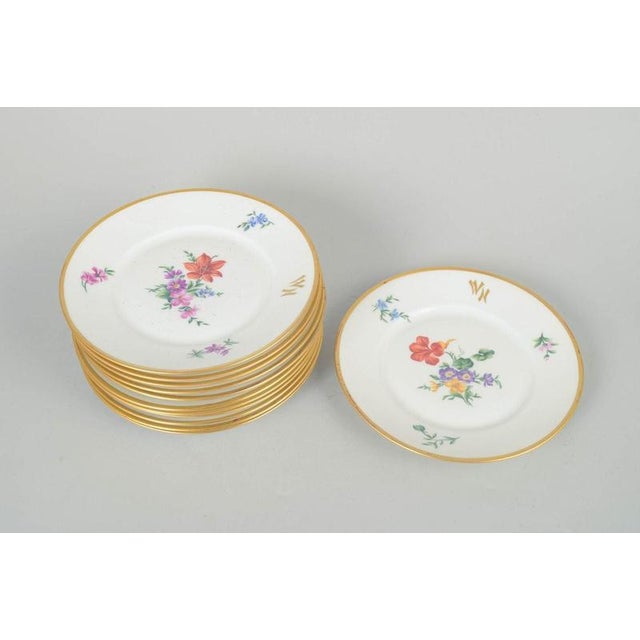 Rosenthal set of twelve plates. Elegant set of twelve porcelain plates with polychrome floral decoration and gilded rim,...