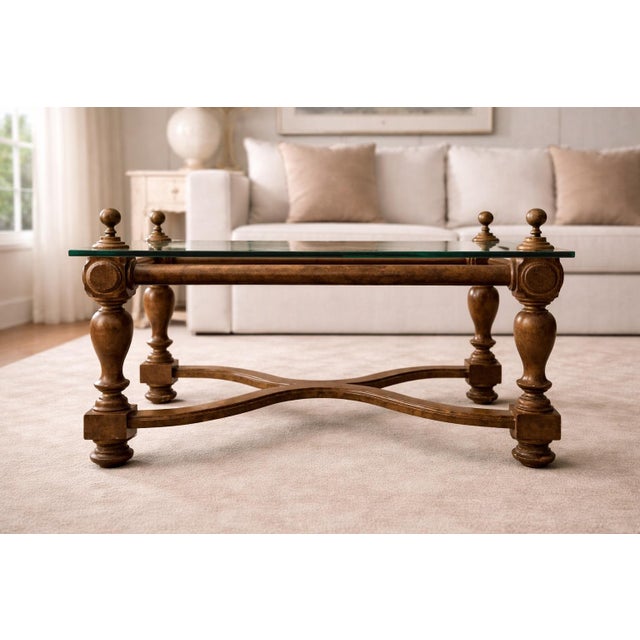 Architectural Neoclassical-style coffee table featuring a sculptural solid wood base, substantial ½-inch beveled glass...