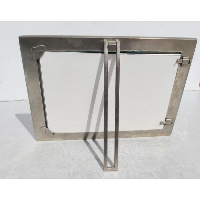Satin Steel Photo frames with a back-stand. marked Wingard San Francisco. Glass faced with dimensions of 9" by 7",...