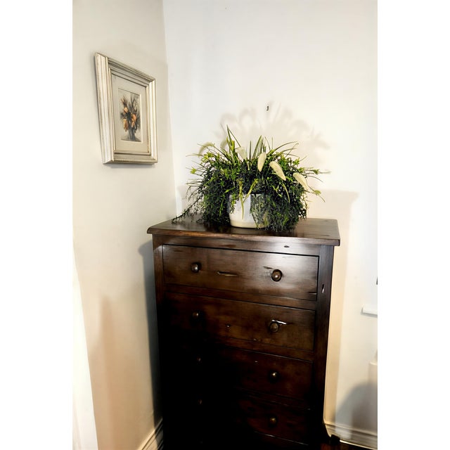 This impressive, solid wood tallboy stands at a commanding height of 48", offering significant storage and a powerful...