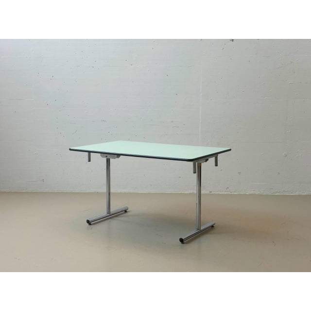 This original kelko folding table impresses with its ingenious folding mechanism and clean, functional design. With just a...