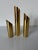 A striking set of three Mid Century Modern brass candle holders, crafted in Denmark. Featuring sleek cylindrical forms...