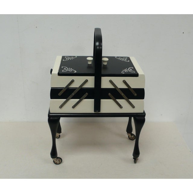 Chippendale-style wooden sewing box on casters, accordion-style drawers, 3 shelves in black and white, refinished with...