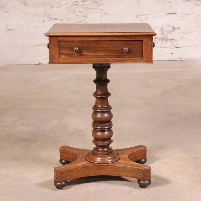 This 19th Century English Walnut Tea Table with Drawer is a charming antique that reflects the refined craftsmanship and...