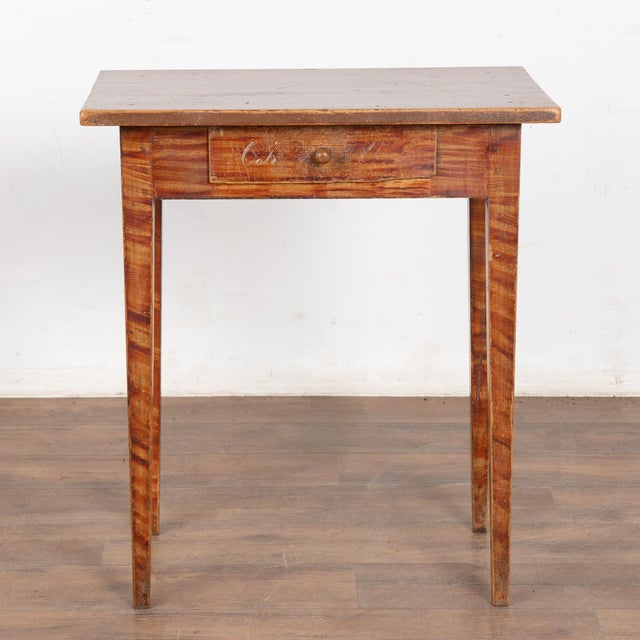 This delightful pine side table comes from the Swedish countryside and still maintains the original faux wood painted...