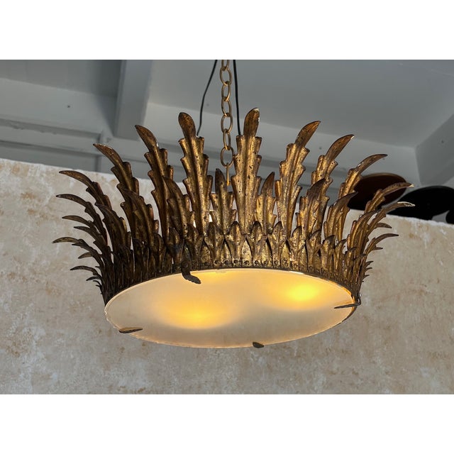This unique large crown ceiling fixture features three rows of elegantly stylized leaf or feather rays that is not only...