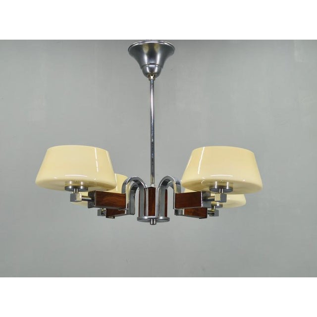 Beautiful Art Deco chandelier produced in Czechoslovakia during the 1930s. This refined ceiling light features a...