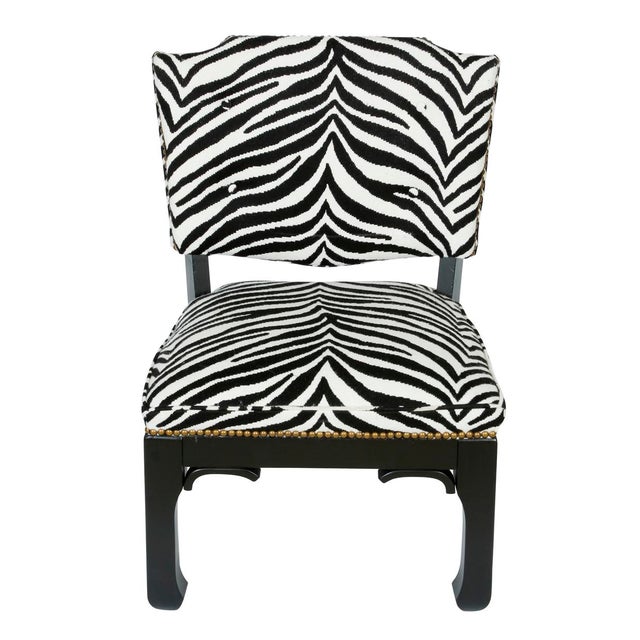 A pair of Asian style chairs in black and white zebra styled after James Mont