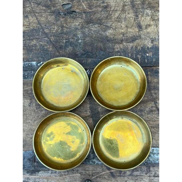 Elevate your bar cart or coffee table with this sophisticated set of four vintage polished brass coasters. A masterclass...