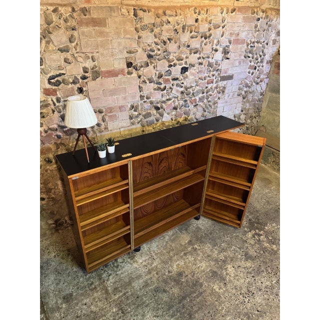 Great example of very rare mid-century teak fold-out bar. Designer/producer unknown. Danish mid-century in design. The bar...