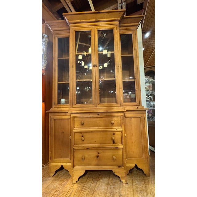 Classic Knotty Pine Breakfront two-piece display cabinet. Beautiful carved detail on the base. Overall, great cabinet with...