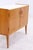 Vintage 1960s chest of drawers with a light wood finish, slender tapered legs, and original handles. Behind the lockable...