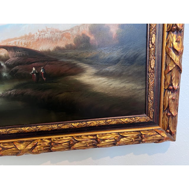 This beautiful antique oil painting on canvas presents a tranquil classical landscape, complete with a serene river, stone...