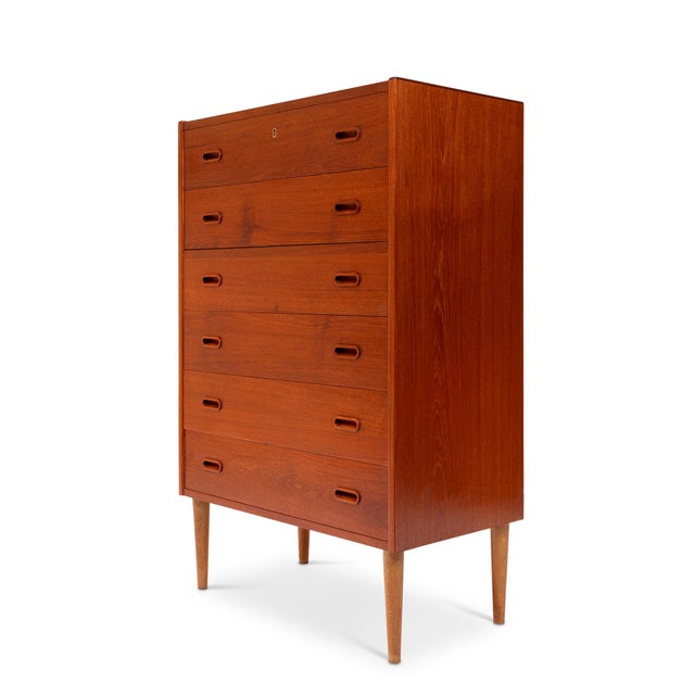 A masterful example of Danish Mid-Century Modern design, this 1960s teak tallboy dresser embodies the harmony of form,...