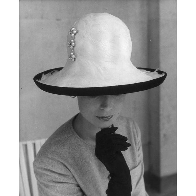 Brimful Of Fashion Fashion model Brenda Harper wearing a Feather Crown on a black velvet Breton shape with a jewel pin at...