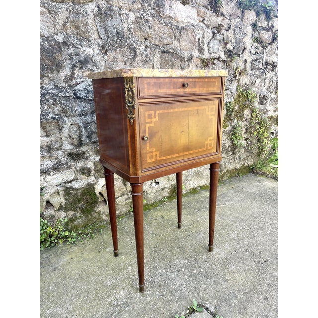 Louis XVI inlaid nightstand in mahogany wood and fruit tree, bronze decoration and marble top, a drawer (36x22x5cm) and a...
