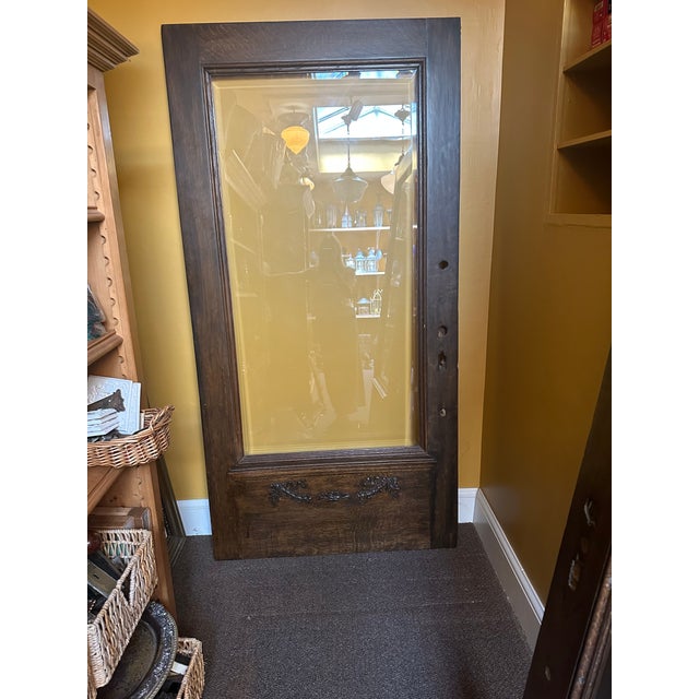 This stained solid oak door is one of a kind. Featuring quarter sawn cut wood with an intricate carved wood appliqué.