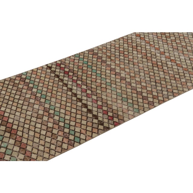 This vintage rug is a 3x10 Turkish distressed piece, made with hand-knotted wool circa mid-20th century. It is an exciting...