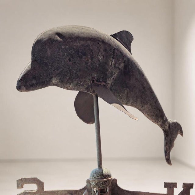 A rare Italian weathervane from the early 1900s, crafted from copper, with a three-dimensional structure and a dolphin...