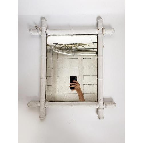 White lacquered bamboo mirror, France, 1930s. Charming wall mirror composed of a turned and white lacquered bamboo frame,...