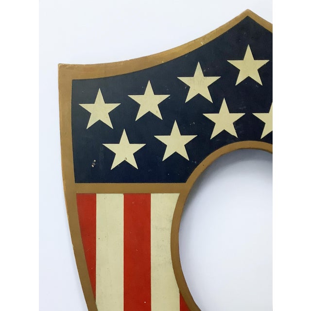 Early 1900s wood painted patriotic picture frame shield with holes on back side to hold five flags. Oval opening for...