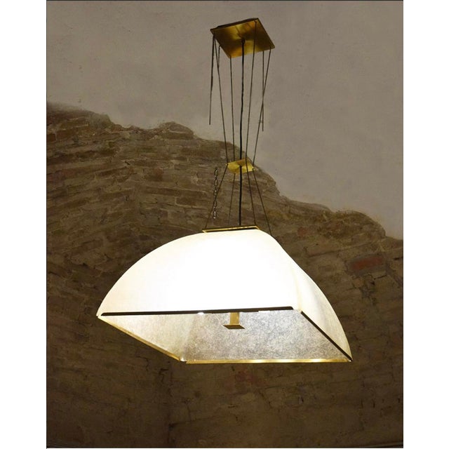 Large Lamperti chandelier made of fiberglass and brass from the 1970s. Fiberglass shade with brass finishes and chains....