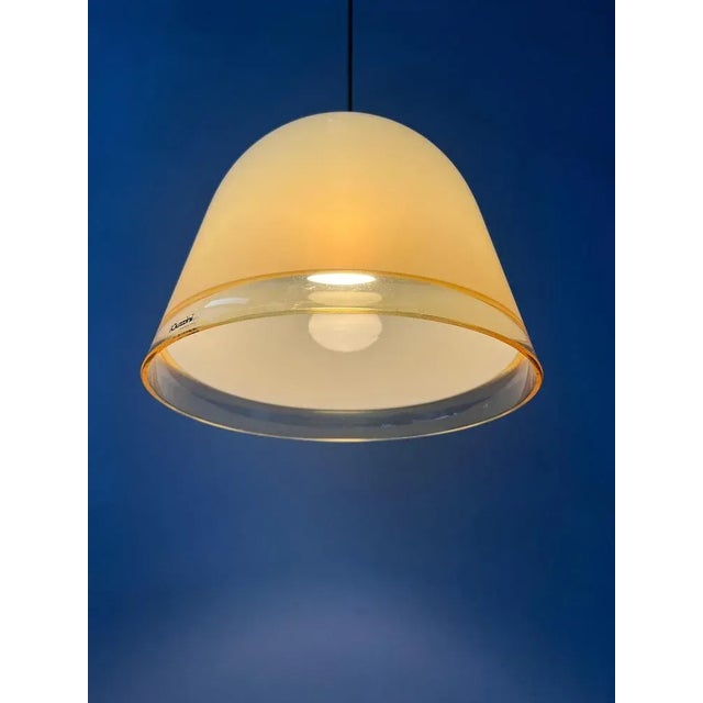 Small Guzzini 'Kuala' space age pendant lamp by Franco Bresciani. The lamp is made from beige acrylic glass and has a gold...