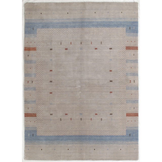Vintage Hand-knotted Gabbeh rug featuring a soft, muted field with subtle tonal variation and a gently defined border. The...