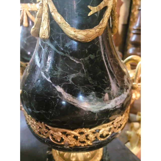 Pair of Louis XVI style cassolettes, in green marble with rich gilded bronze ornamentation: ram heads, garlands of flowers...