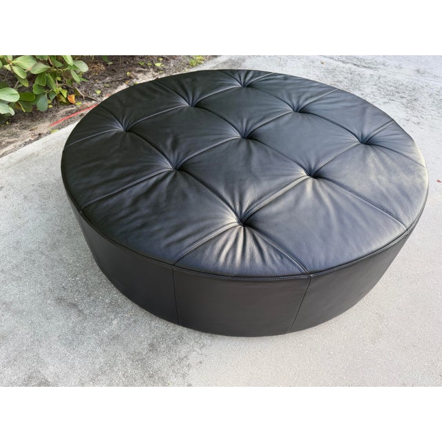 Designed and handcrafted in Italy by Poltrona Frau, this authentic Cubo D120 ottoman is upholstered in premium black Pelle...