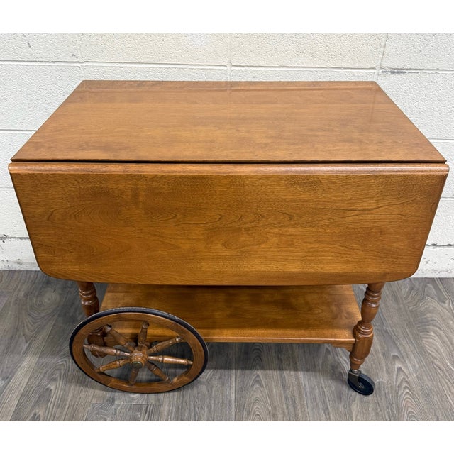 This is a gorgeous vintage Ethan Allen by Baumritter solid maple drop-leaf tea cart 16-52”1. Features classic Early...
