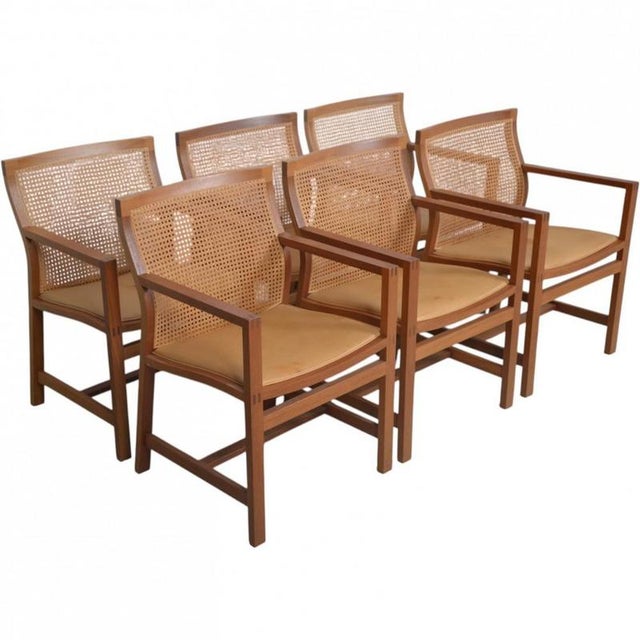 Set of 6 Rud Thygsen & Johnny Sørensen King armchairs with frames of mahogany, wicker backs, and upholstered seat cushions...