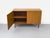 Teak sideboard with two handleless cabinet doors featuring solid wood edges. Beautiful grain and high-quality...