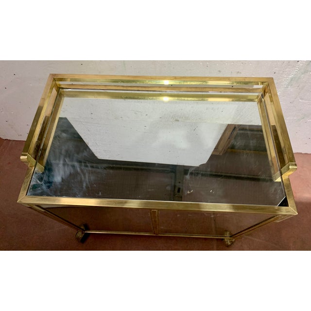 1970s bar cabinet on casters Square brass tube frame All sides are mirrored panels Very good overall condition Dimensions:...