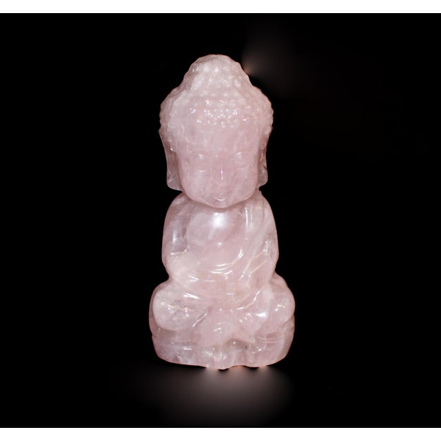 A luminous Baby Buddha sculpture, hand carved from solid, natural fine-grade rose quartz and polished to a silky smooth...
