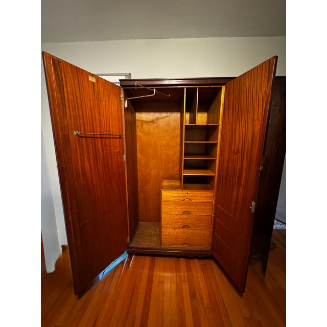 An exceptional English Art Deco wardrobe by Warings, featuring the original “Perfection Wardrobe” brass manufacturer’s...