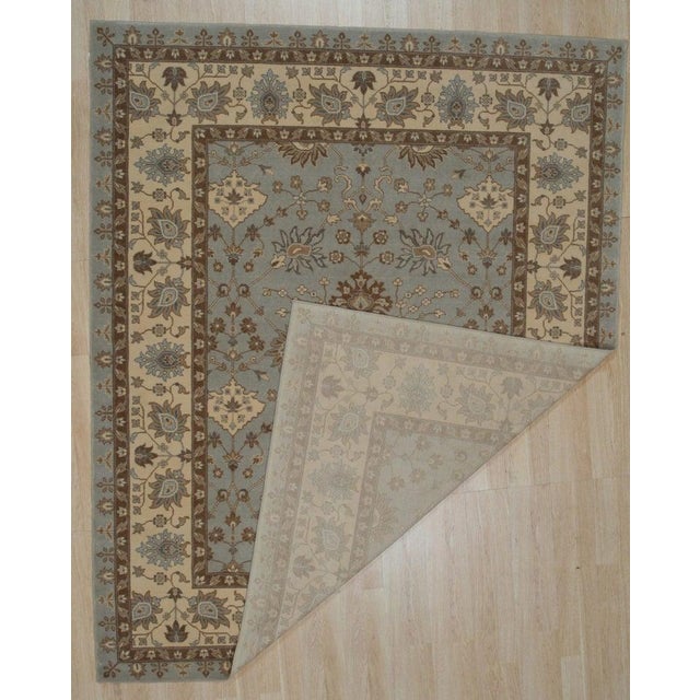 This blue wool runner rug features a classic Oushak style design suitable for residential settings. It is constructed...