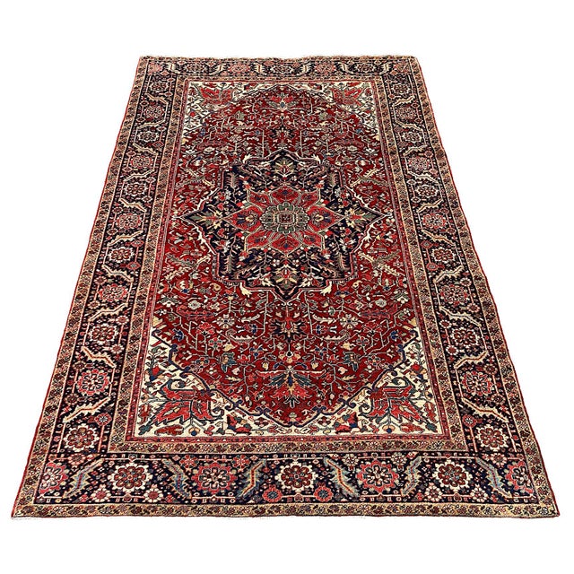 A wonderful antique Heriz rug, hand woven circa 1920. The design features a large, geometrical central medallion...