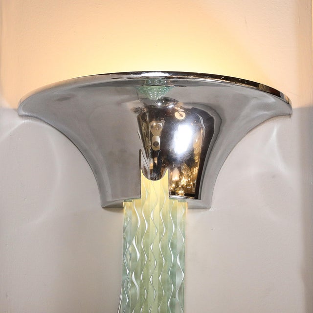 A stunning Mid-Century Modernist waterfall sconce by celebrated American designer Karl Springer, circa 1980. This...