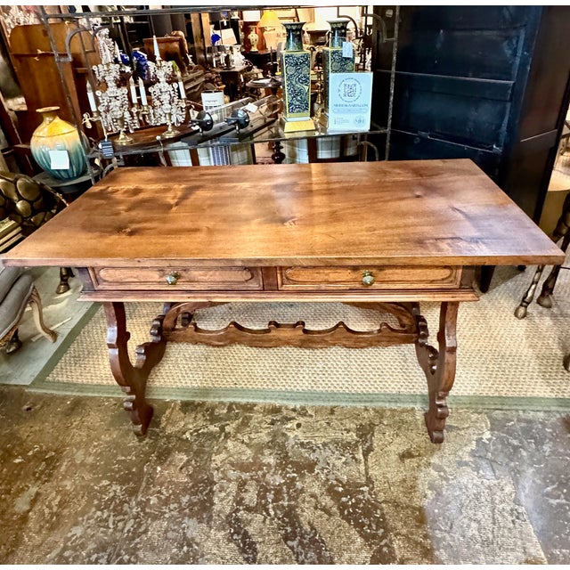 This is a wonderful side or writing table in solid walnut that perfectly adheres to the Baroque aesthetic. The table has...